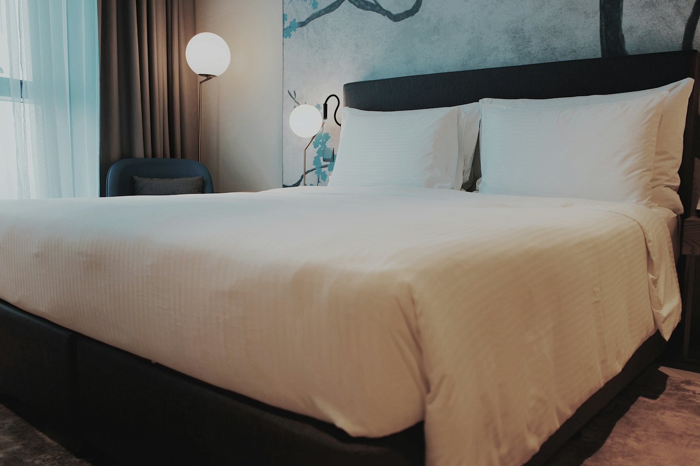 King-size bed with white linens in a hotel room.