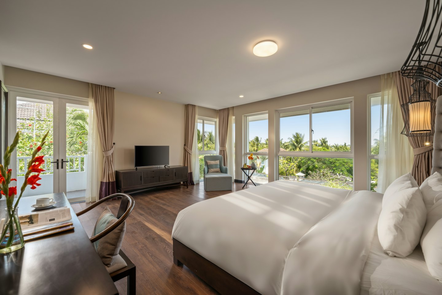 Hotel room with a king bed and tropical view.