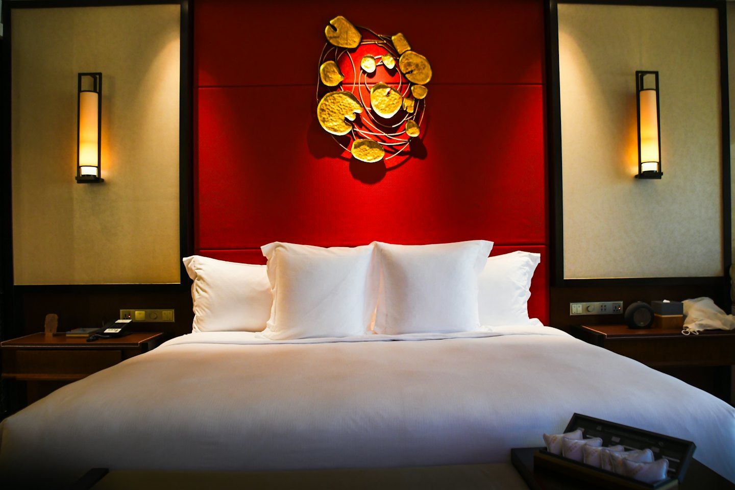 King size bed with white bedding and a red headboard.