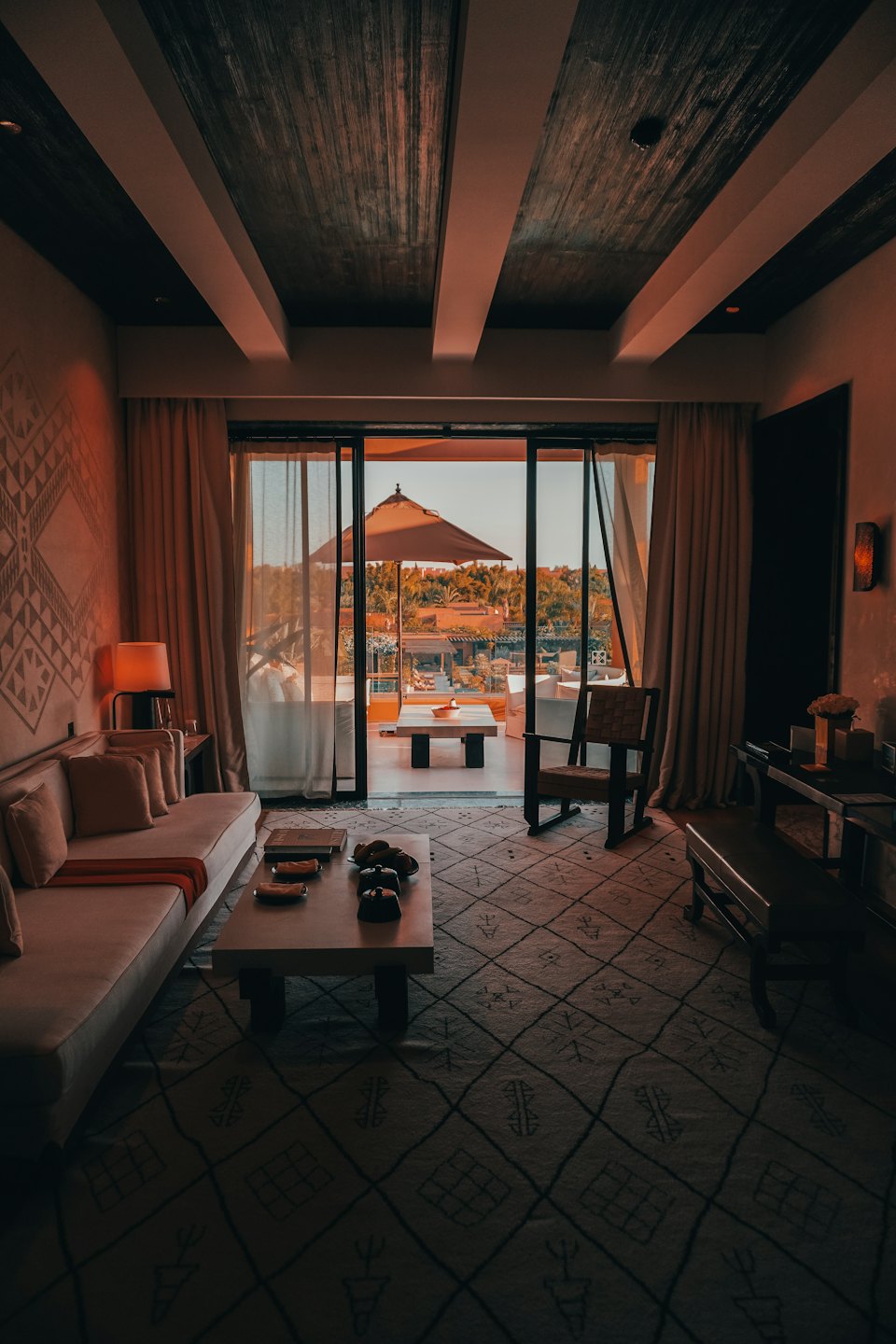 Luxury hotel suite with sofa and patio access.